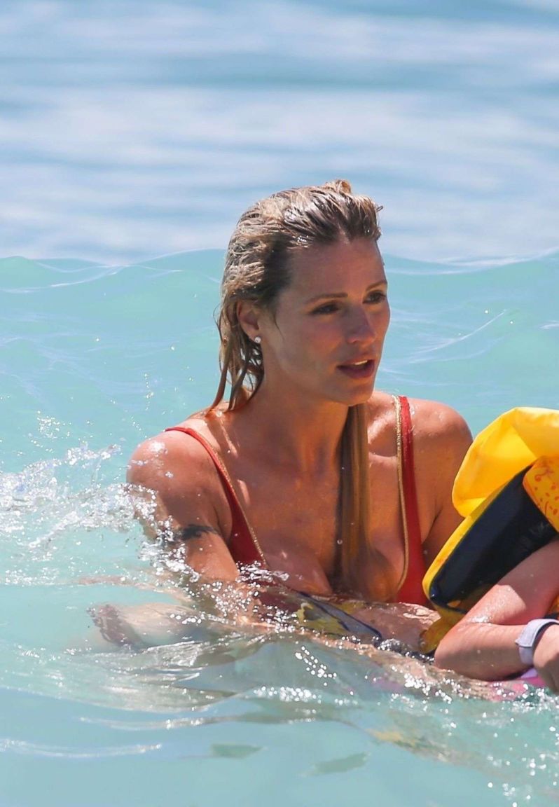 Michelle Hunziker Enjoying The Waves In An Orange Bikini